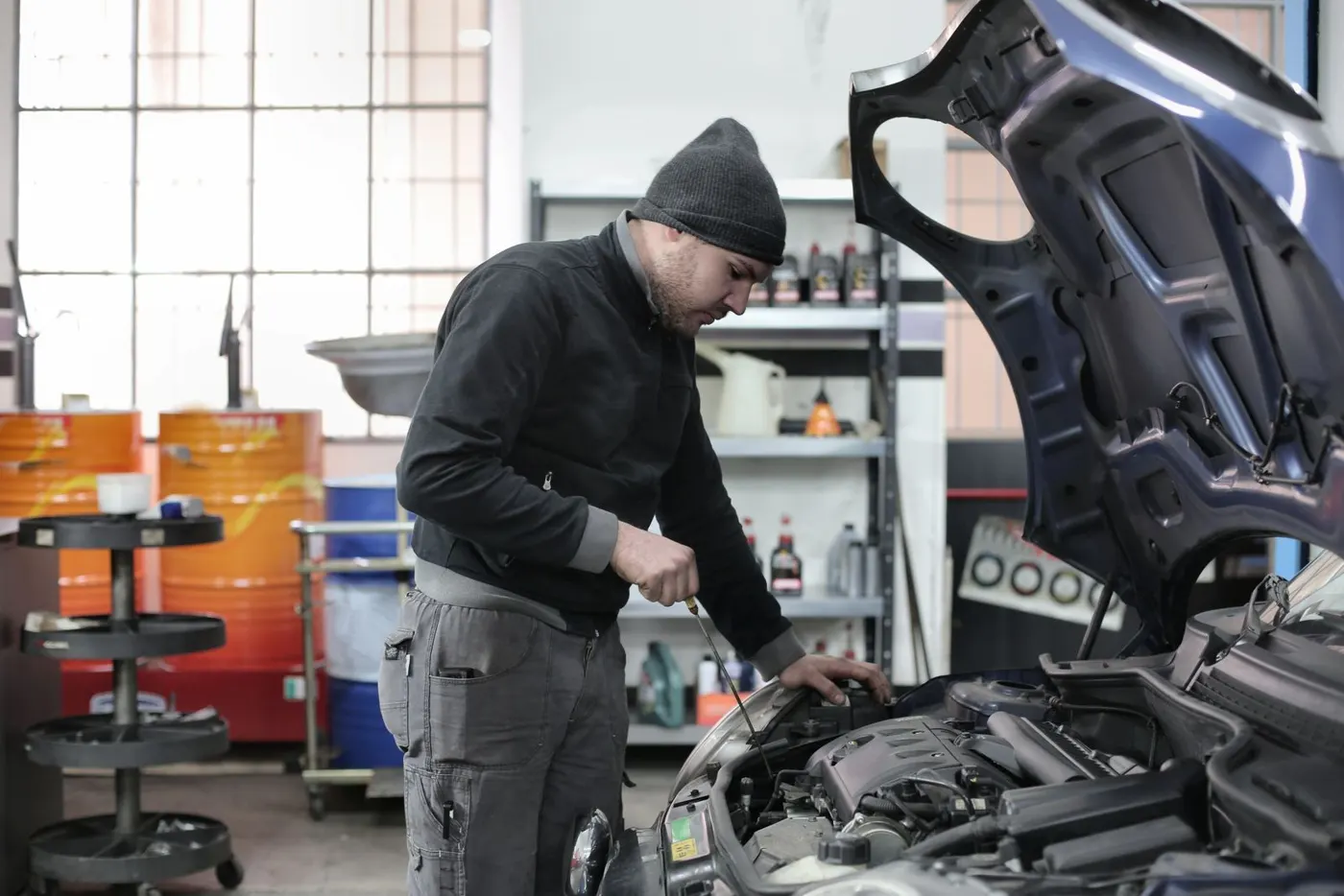 Technician inspecting an engine in the bay